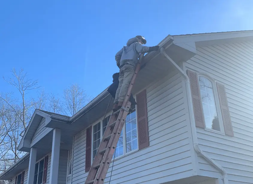 Gutter cleaning and maintenance being performed by Medina Power Washing in Medina